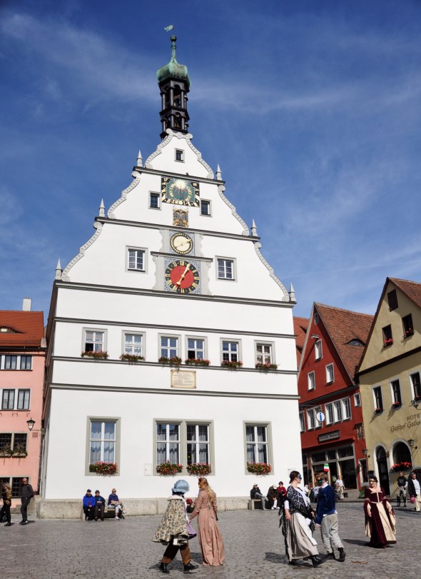 Dancers from an English visiting theatre company perform in front of the tourist office, housed in a former tavern